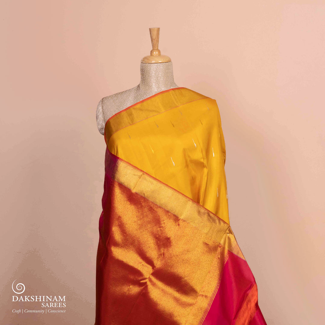 Full view of a Yellow Korvai Kanjivaram silk saree with red temple border.