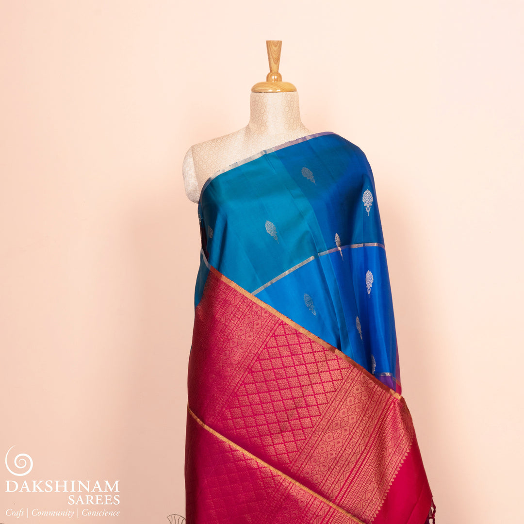 Full view of a Multicolor soft silk saree with red pallu and zari floral buttas.