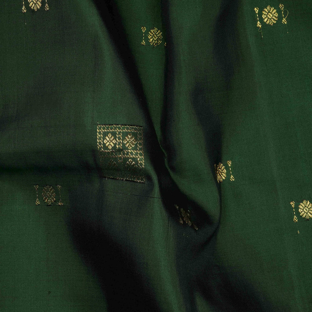 Close-up of green fabric with gold embroidery