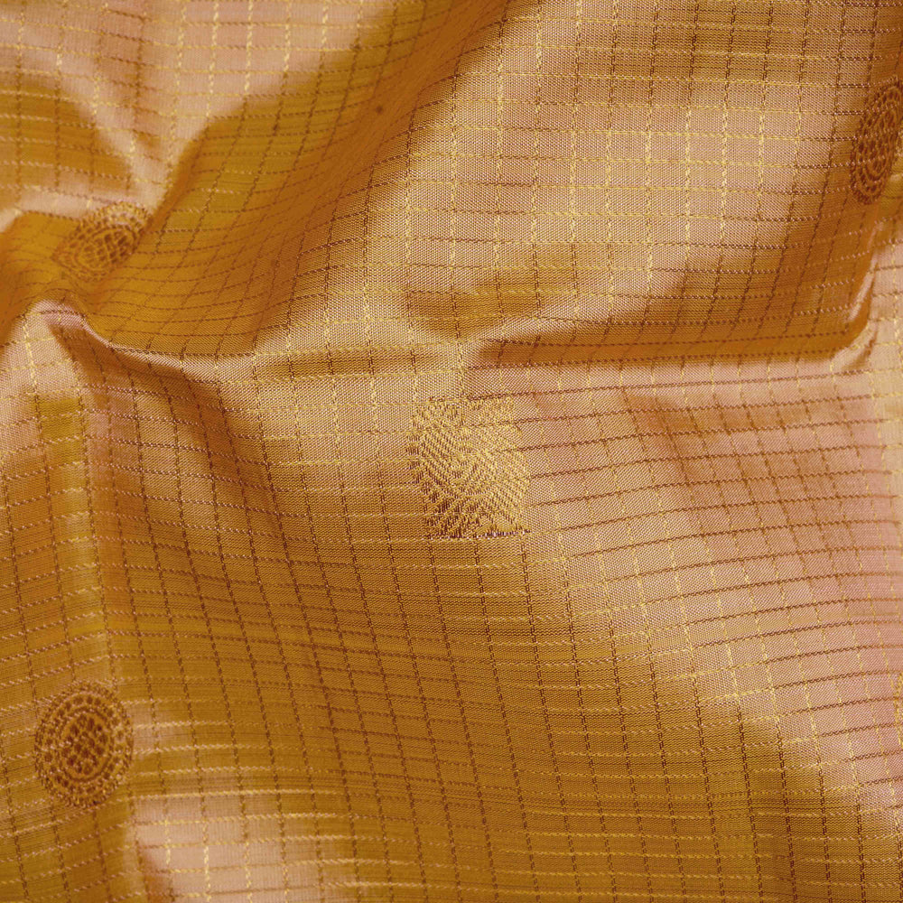 Close-up of textured gold fabric with intricate patterns