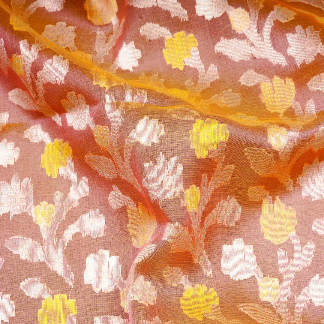 Close-up of floral patterned fabric with yellow, white, and orange colors.