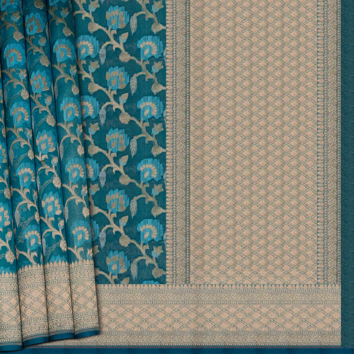 Teal and beige patterned fabric with floral design