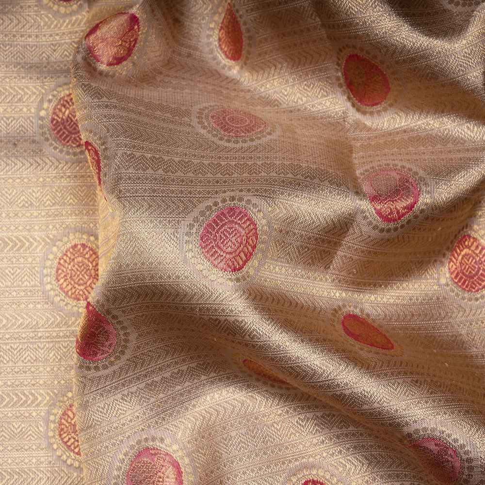 Close-up of beige fabric with red and pink circular patterns