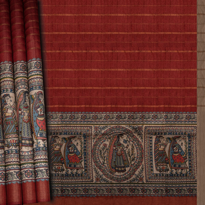 Red fabric with intricate patterns and designs, featuring people and possibly animals, on a plain background.