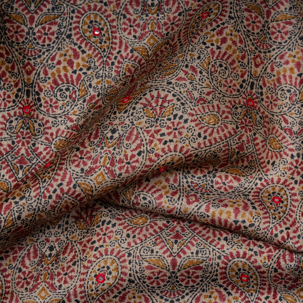 Close-up of patterned fabric with red, black, and gold colors.
