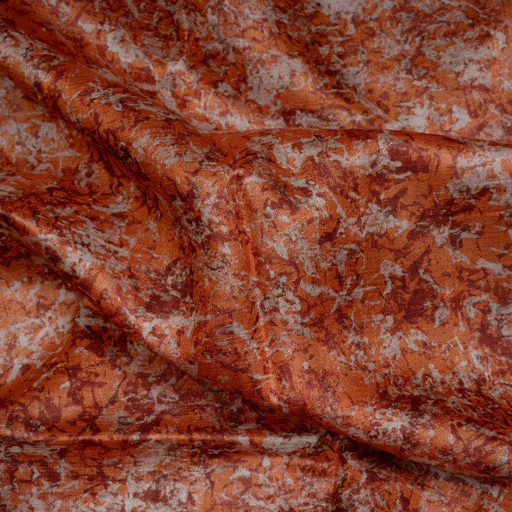 Close-up of textured orange fabric with a subtle pattern