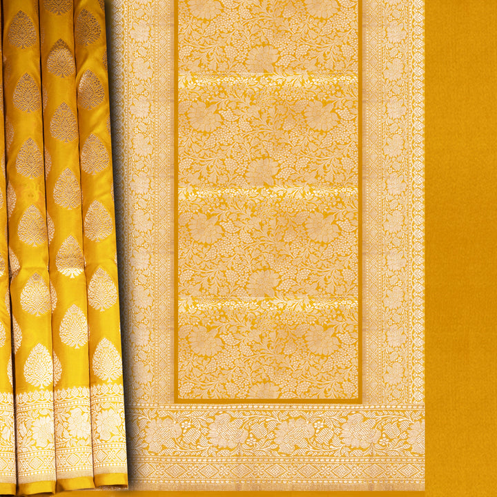Close-up of a yellow fabric with intricate patterns and designs.