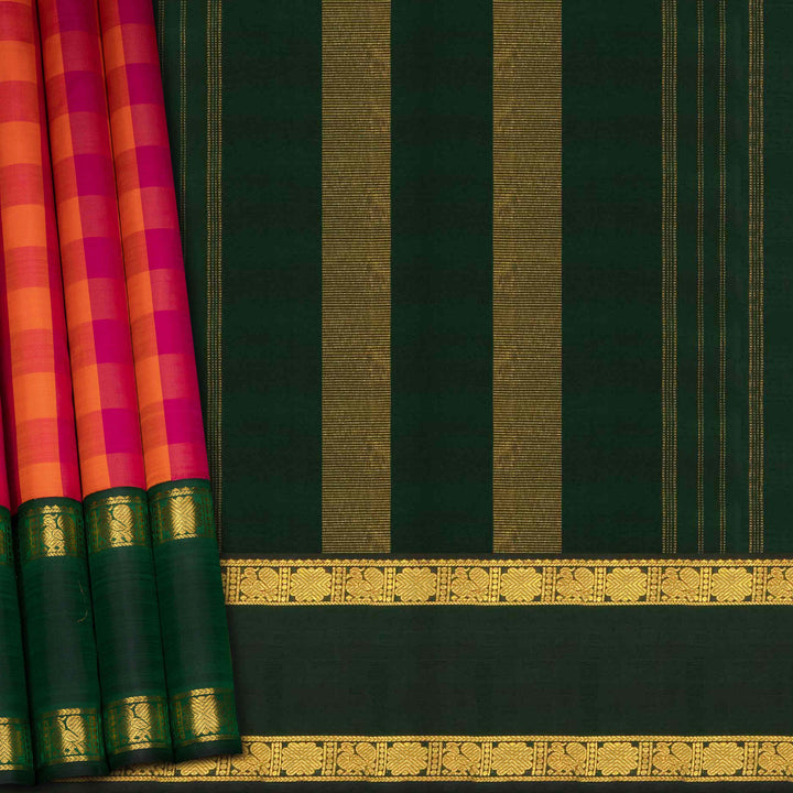 Green saree with gold border and pink and orange checkered pattern on the side