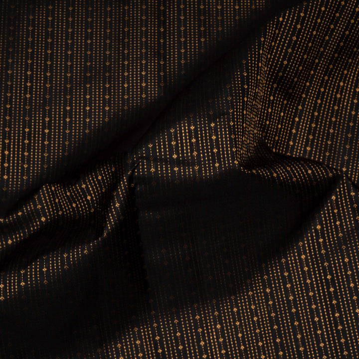 Close-up of black fabric with gold thread pattern