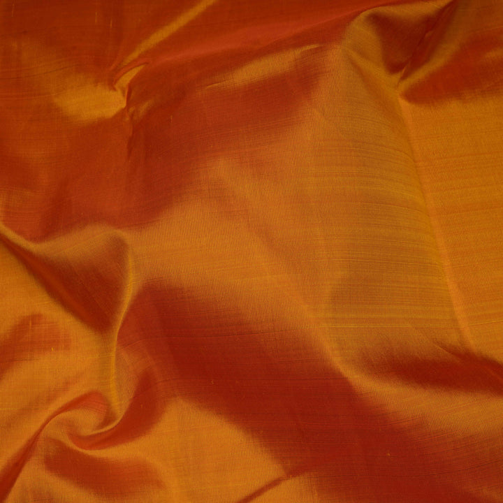Close-up of orange fabric with a textured surface