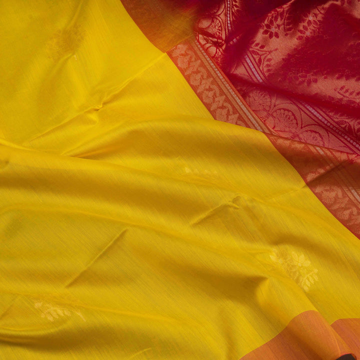 Close-up of a yellow fabric with a red and gold border