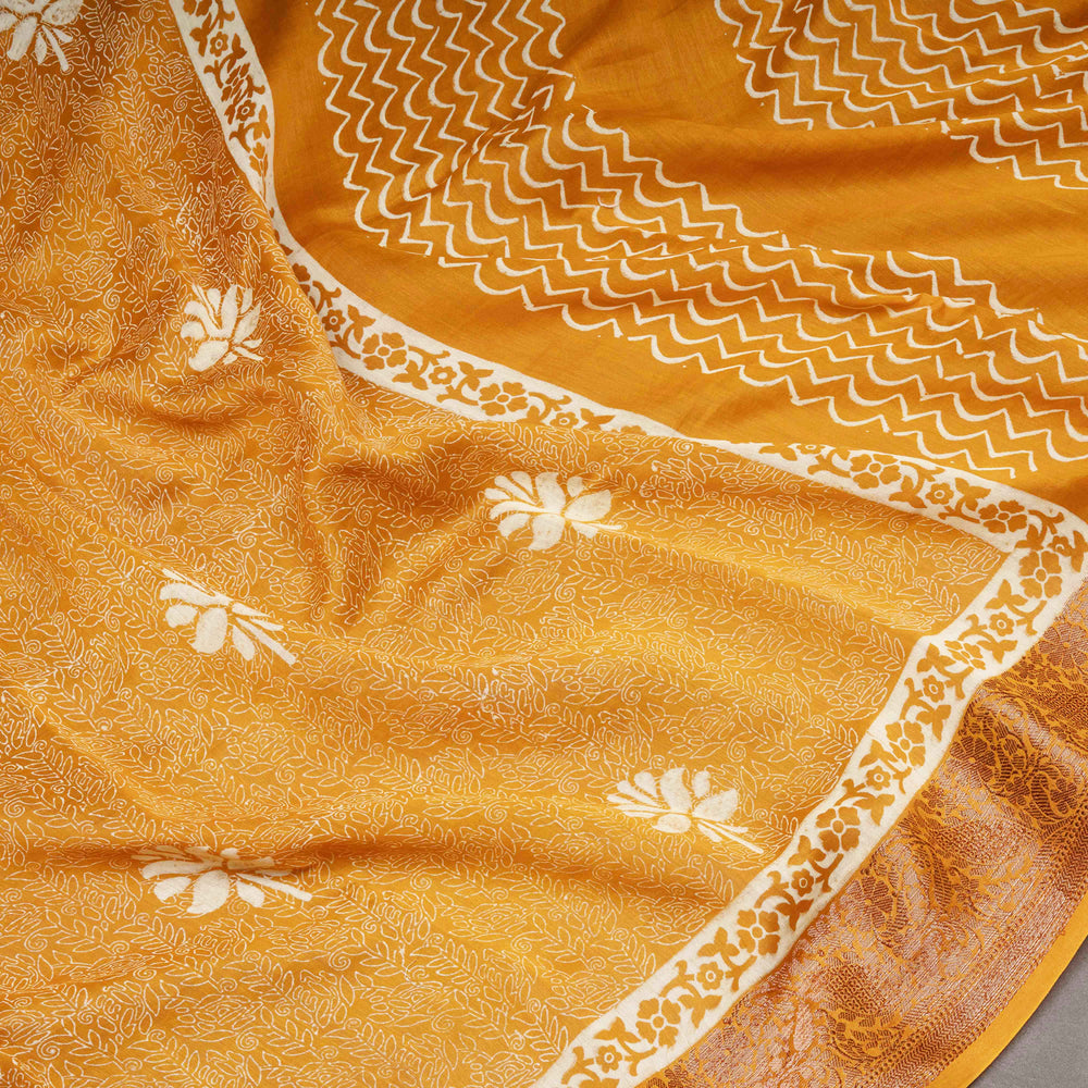 Close-up of a yellow fabric with white floral patterns and border