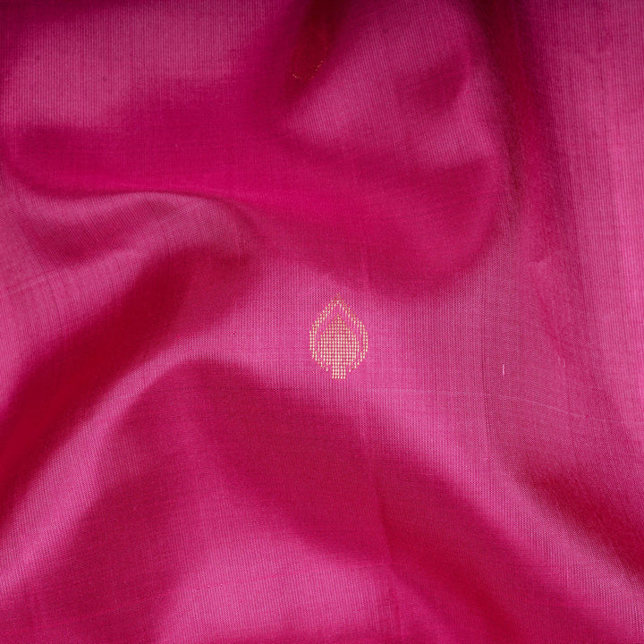 Close-up of pink fabric with a small embroidered design.