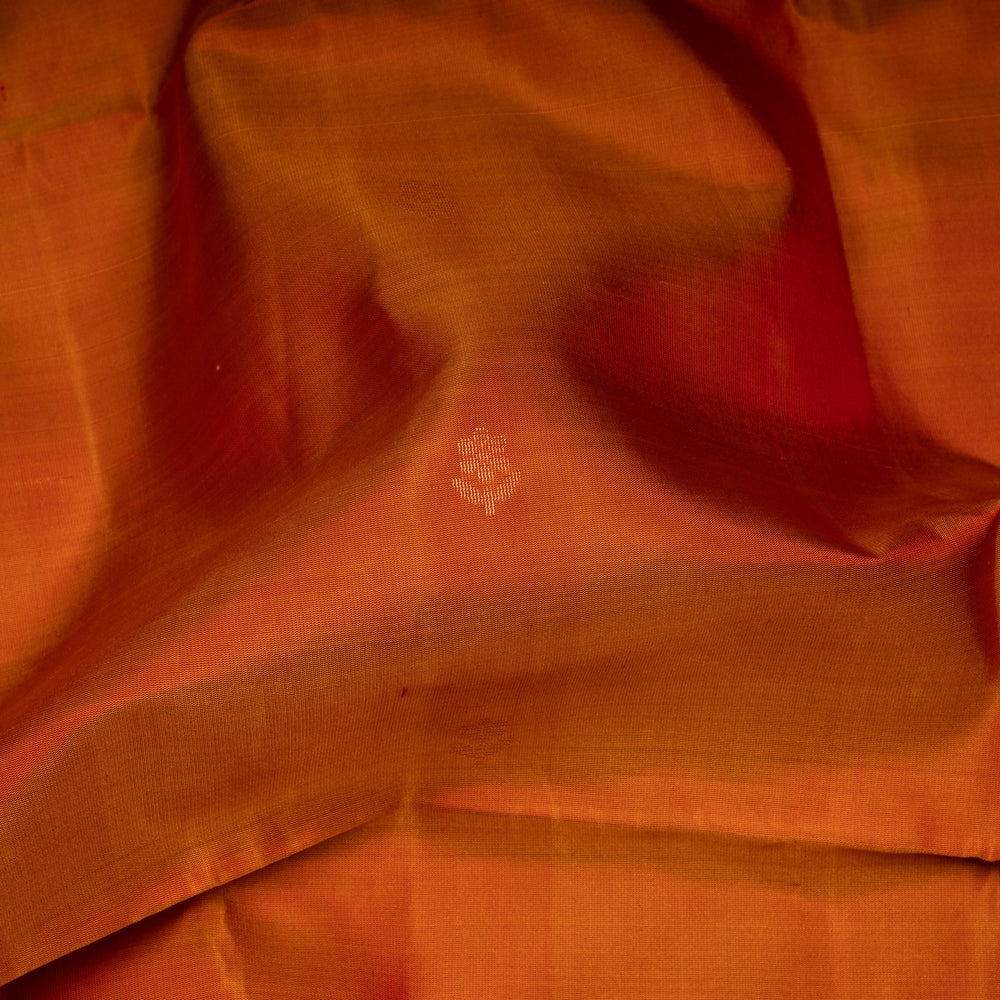 Close-up of orange fabric with a subtle pattern