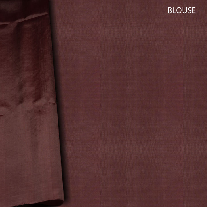 Close-up of a brown fabric with 'BLOUSE' text on a plain background