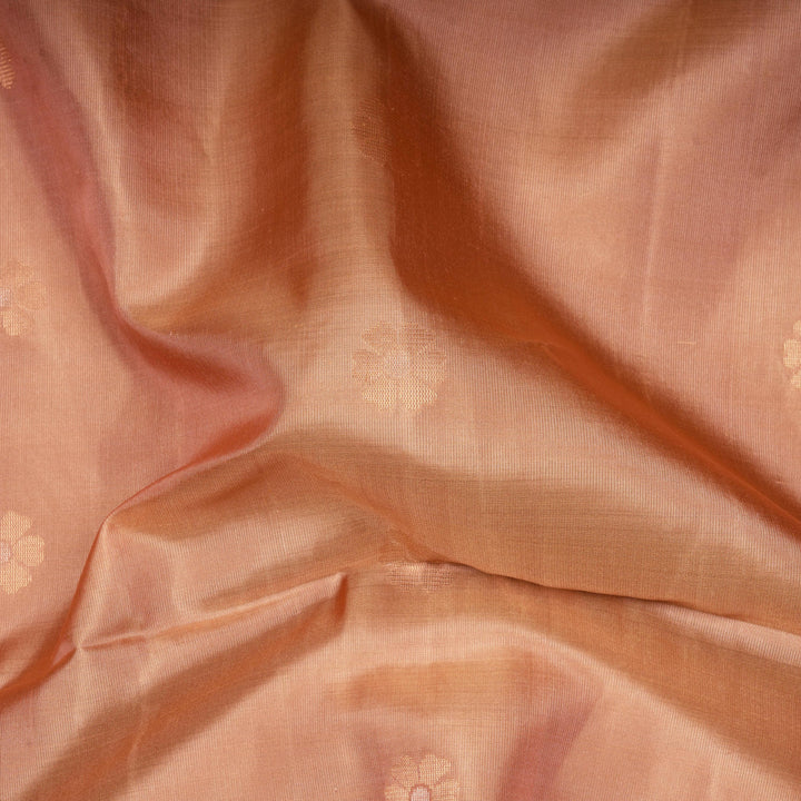 Close-up of peach-colored fabric with subtle patterns
