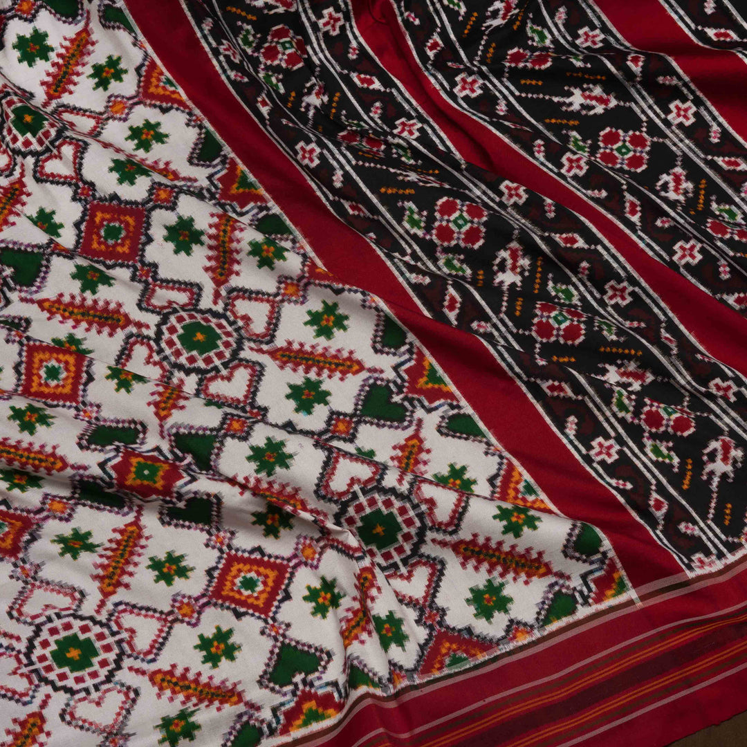 Close-up of patterned fabric with red, green, and black colors.