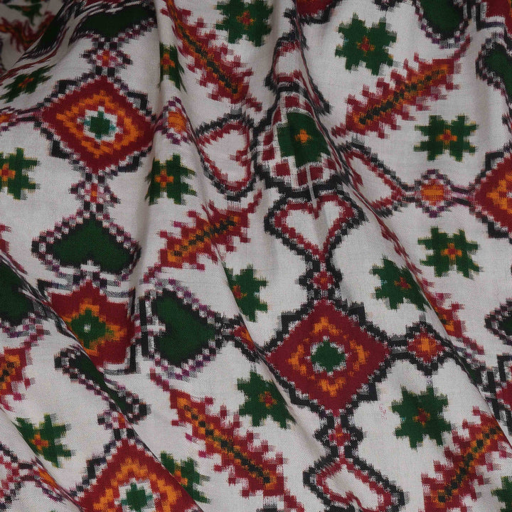 Close-up of fabric with a colorful geometric pattern on a white background