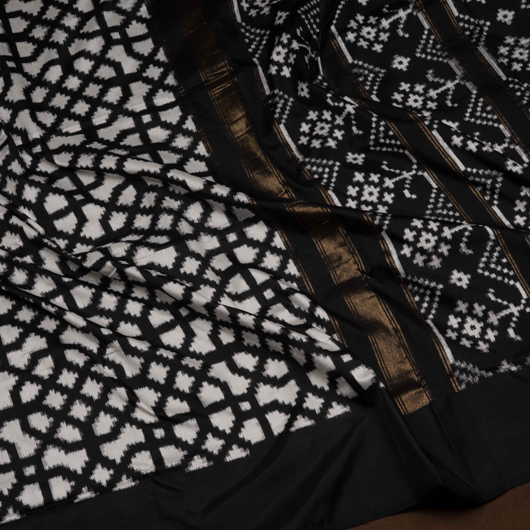 Close-up of black and white patterned fabric with a brown border.