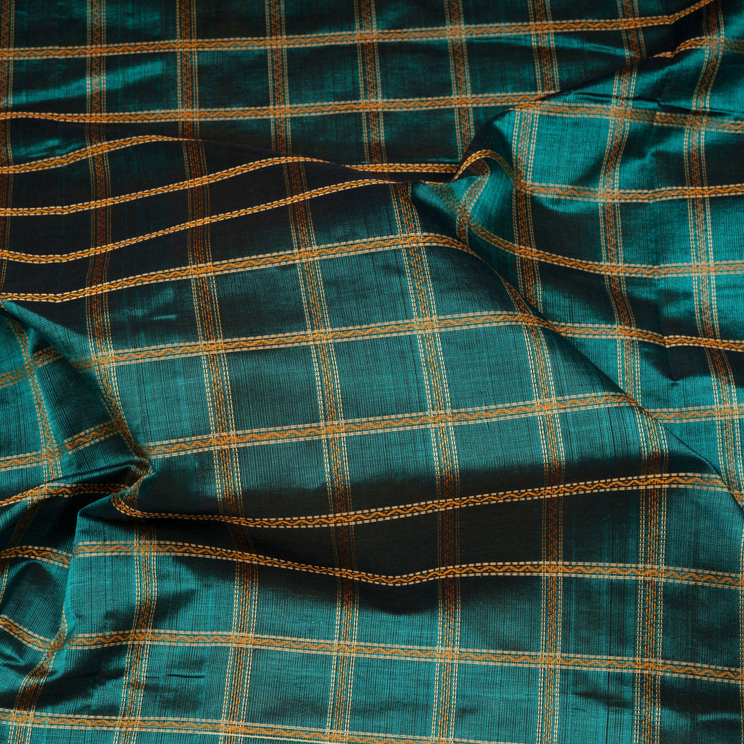 Checked dark green silk cotton saree with rettapet temple border and gold zari pallu design