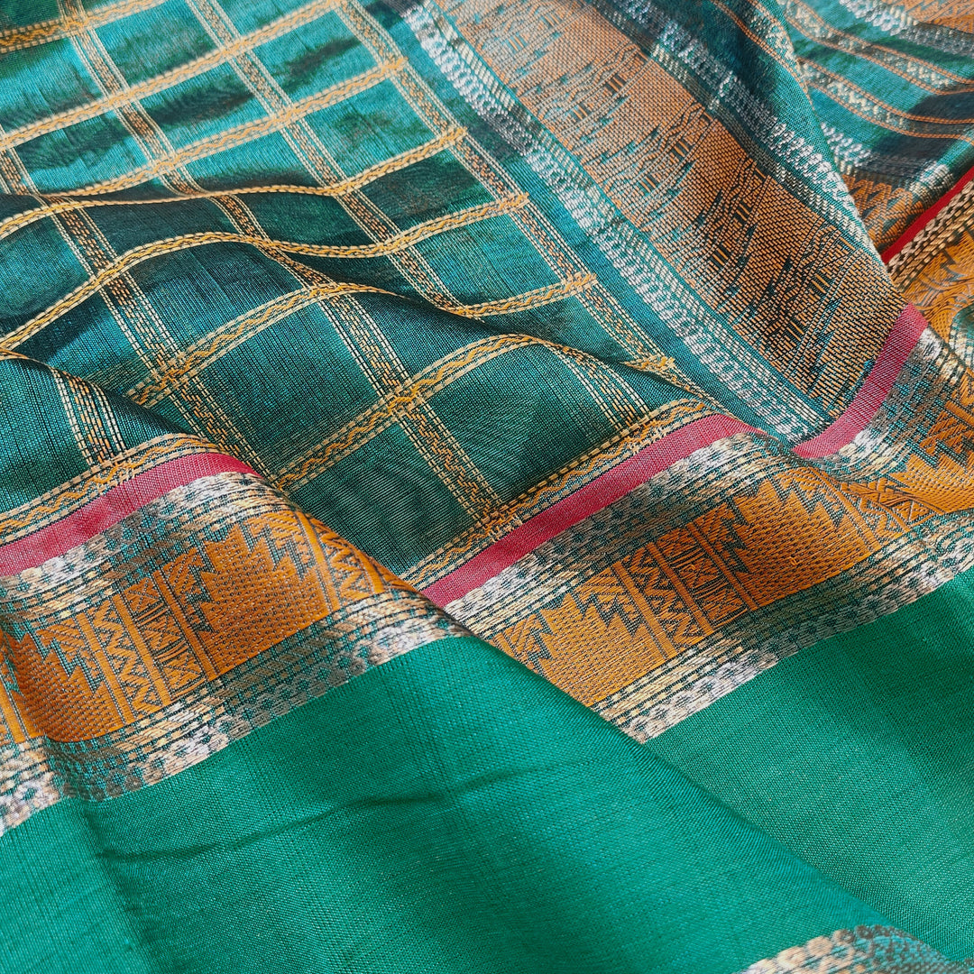 Checked dark green silk cotton saree with rettapet temple border and gold zari pallu design