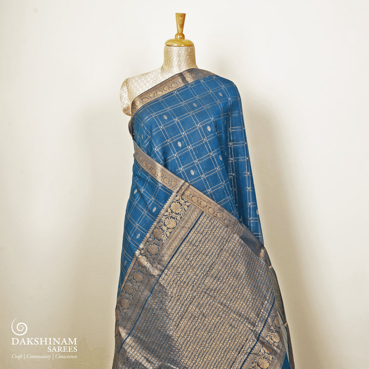 Blue checked silk cotton saree with gold zari border featuring leaf motifs and dotted check pattern