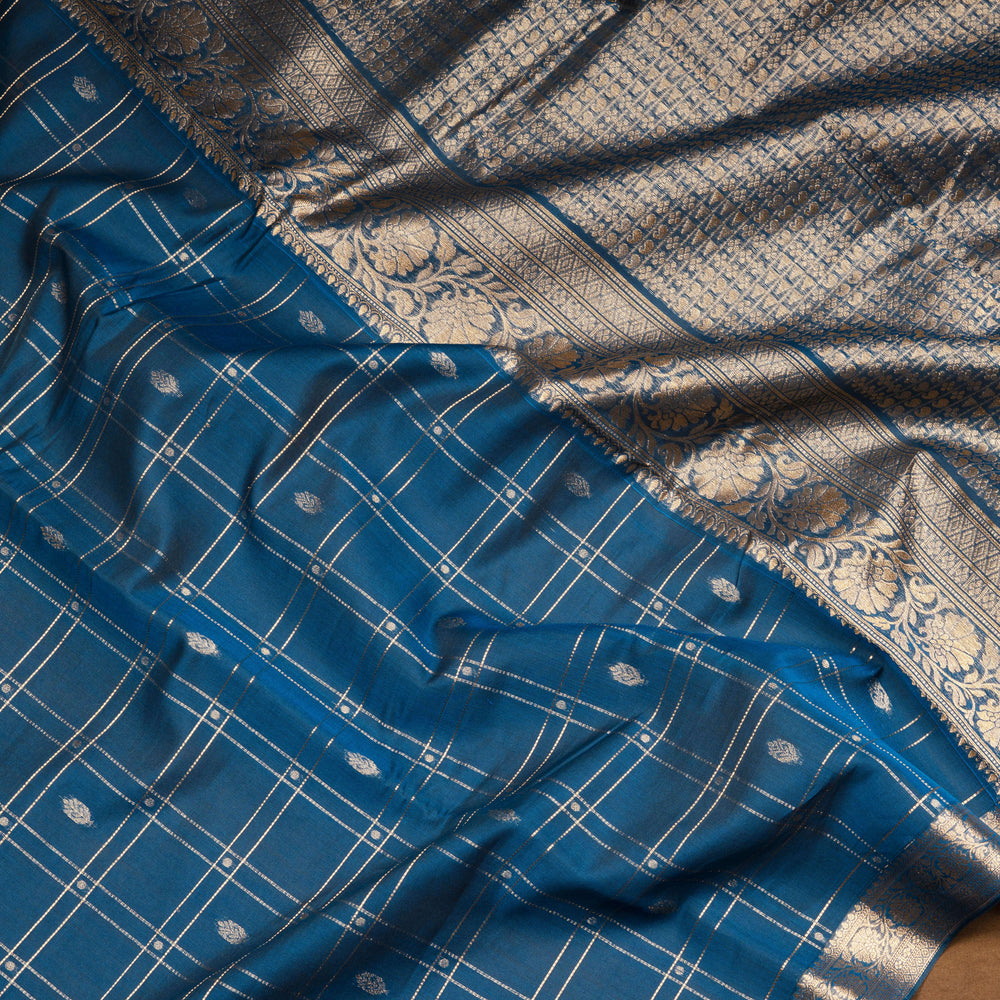 Blue checked silk cotton saree with gold zari border featuring leaf motifs and dotted check pattern