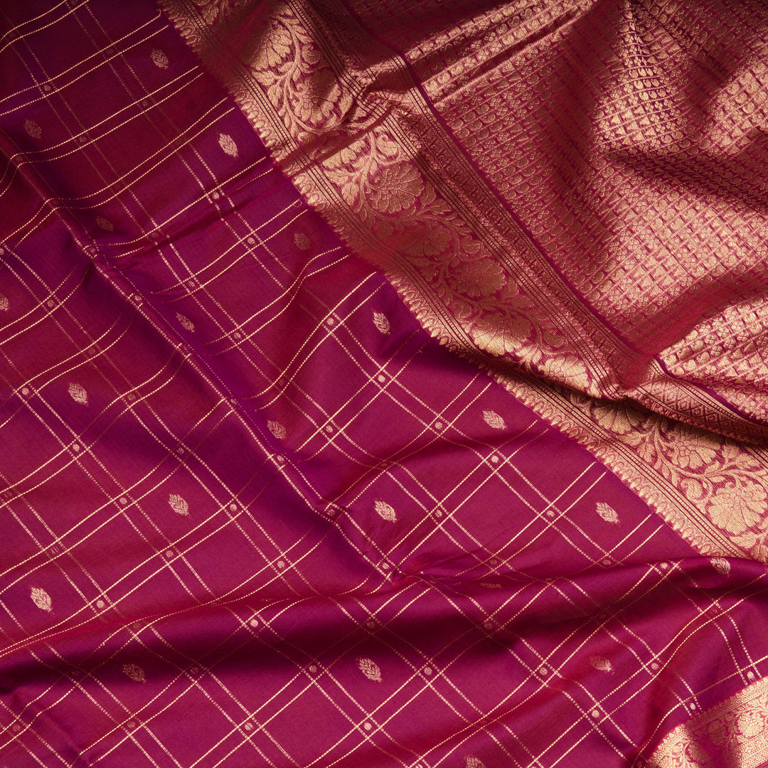 Magenta checked silk cotton saree with gold zari border featuring leaf motifs and dotted check pattern