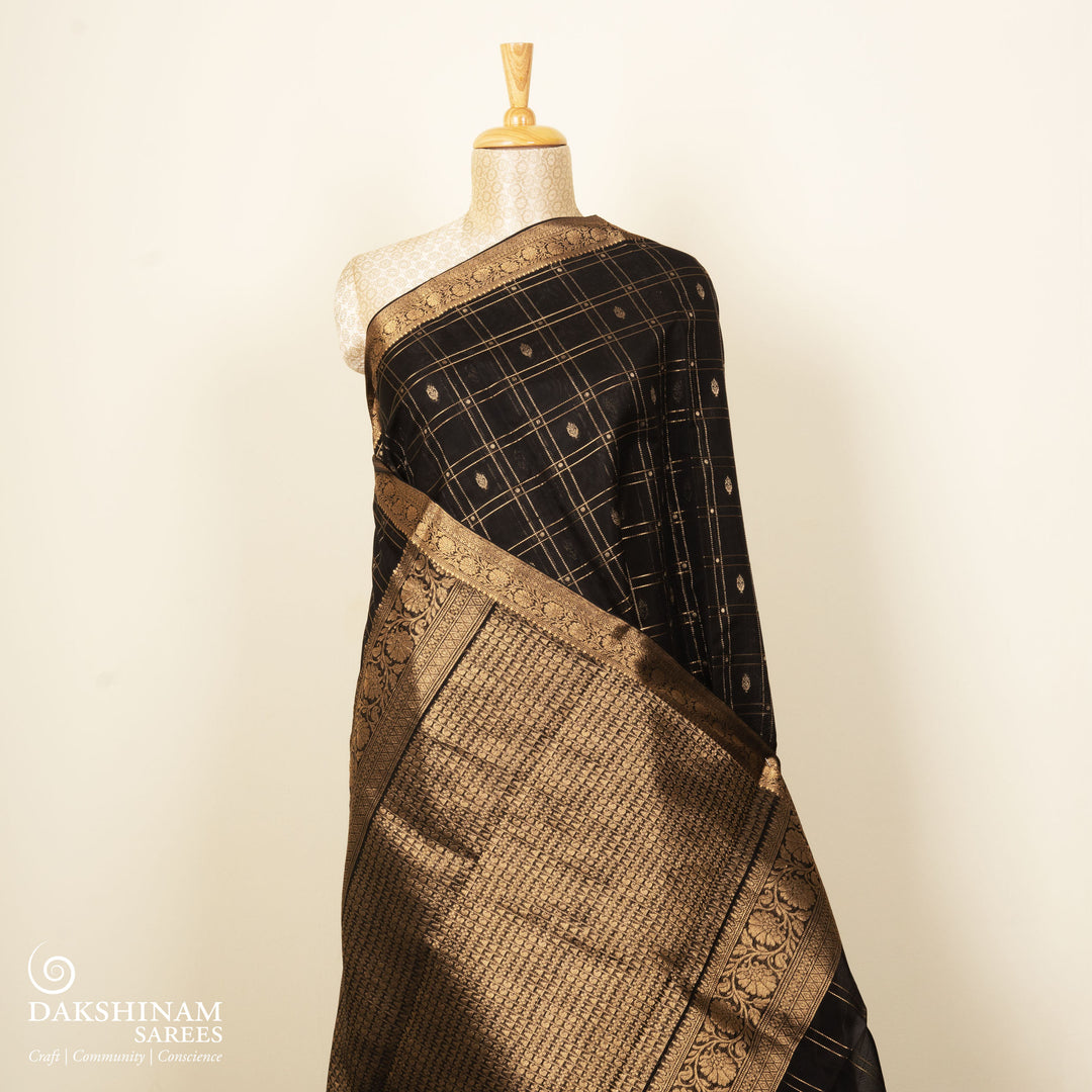 Black checked silk cotton saree with gold zari border featuring leaf motifs and dotted check pattern