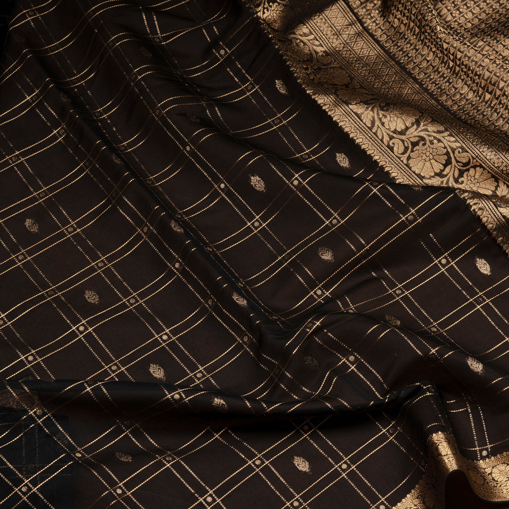 Black checked silk cotton saree with gold zari border featuring leaf motifs and dotted check pattern