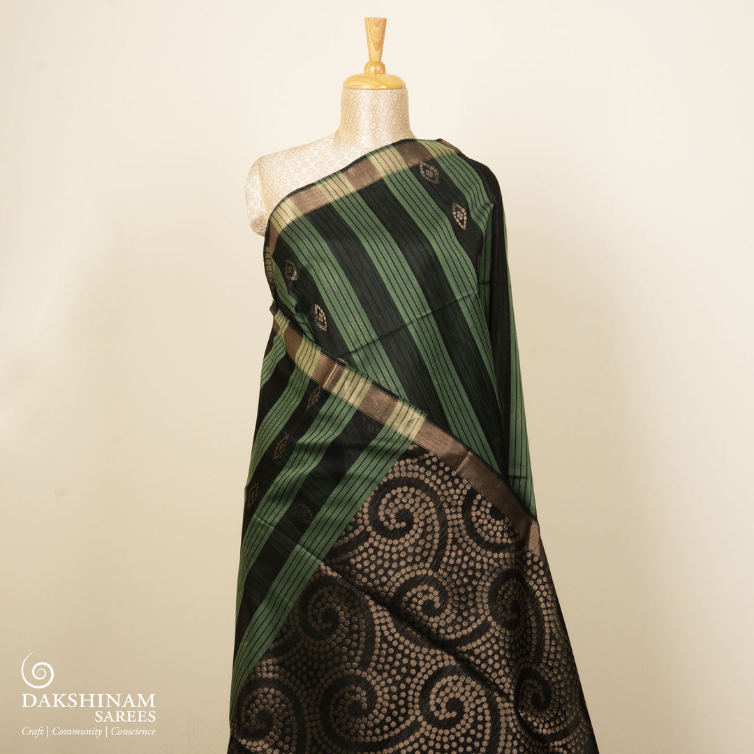 Black and light green silk cotton saree with gold zari border, striped panels and diamond butta motifs