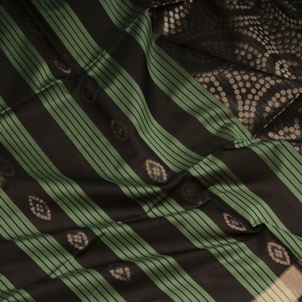 Black and light green silk cotton saree with gold zari border, striped panels and diamond butta motifs