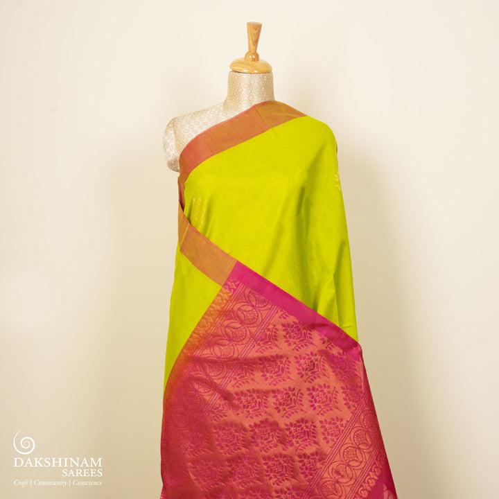 Lime green silk cotton saree with tree of life motifs, rust orange border and magenta pallu with zari detailing