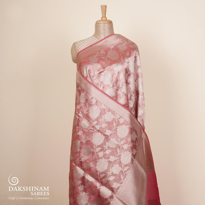 Light pink organza Banarasi silk saree with floral zari vines and zigzag patterned border
