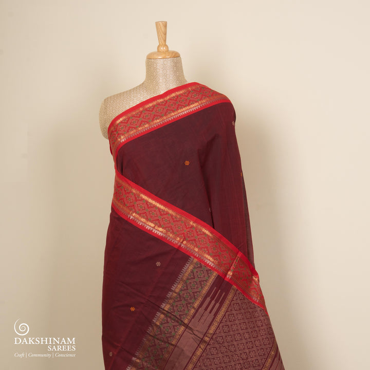 Maroon Kanchi cotton saree with traditional rudraksh, temple and diamond motifs and detailed pallu design