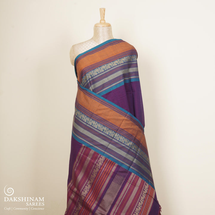 Purple Kanchi cotton saree with plain body, mango design border, mayil butta and traditional pallu with matching blouse