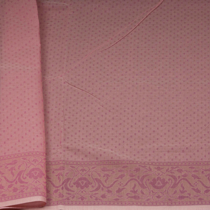 Pink South cotton saree with plant and paisley motifs across the body, floral border and peacock motif pallu, matching blouse with diamond butta design.