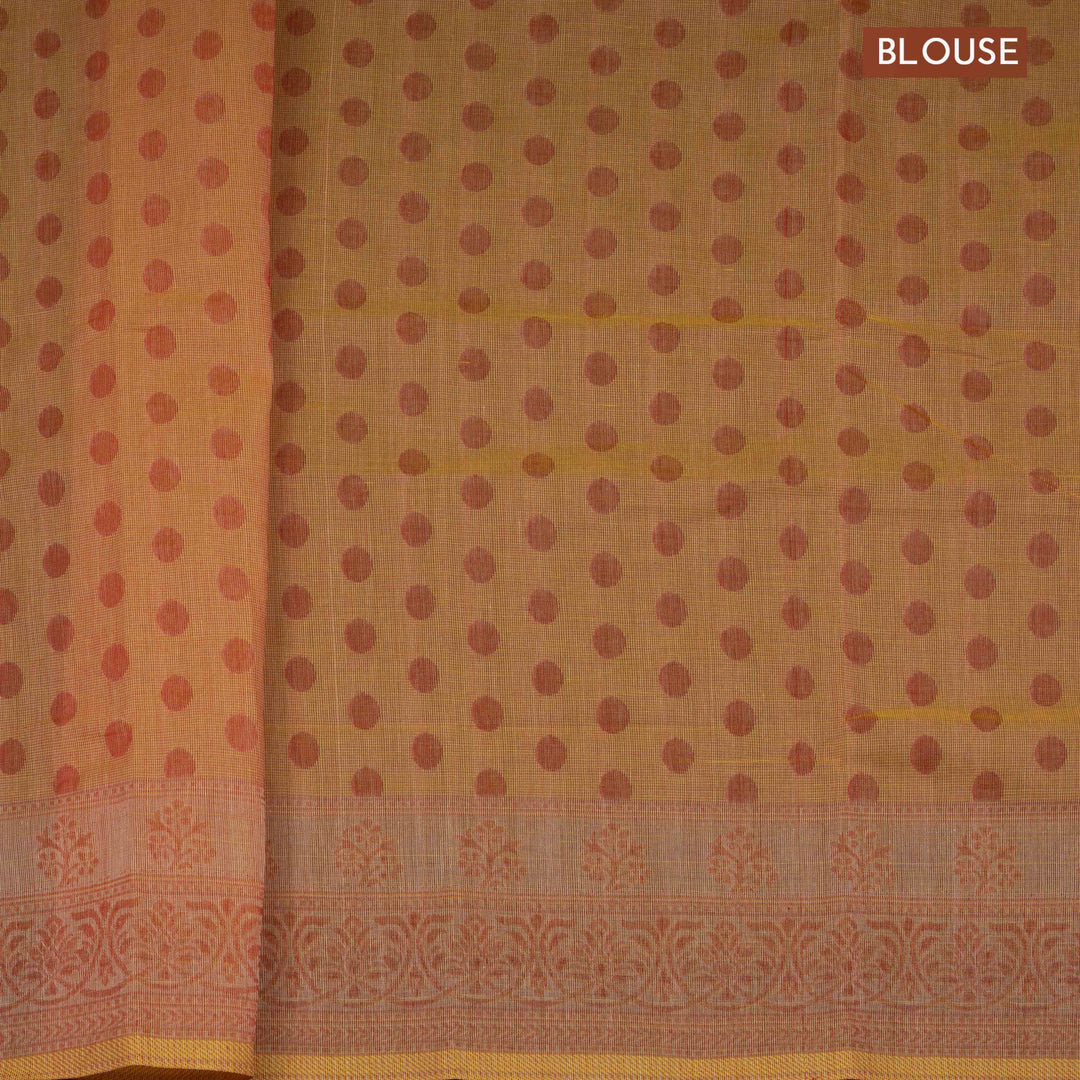 Orange South cotton saree with floral body featuring peacock, horse, elephant, deer and tiger motifs, traditional border and paisley pallu, matching blouse with dot design.