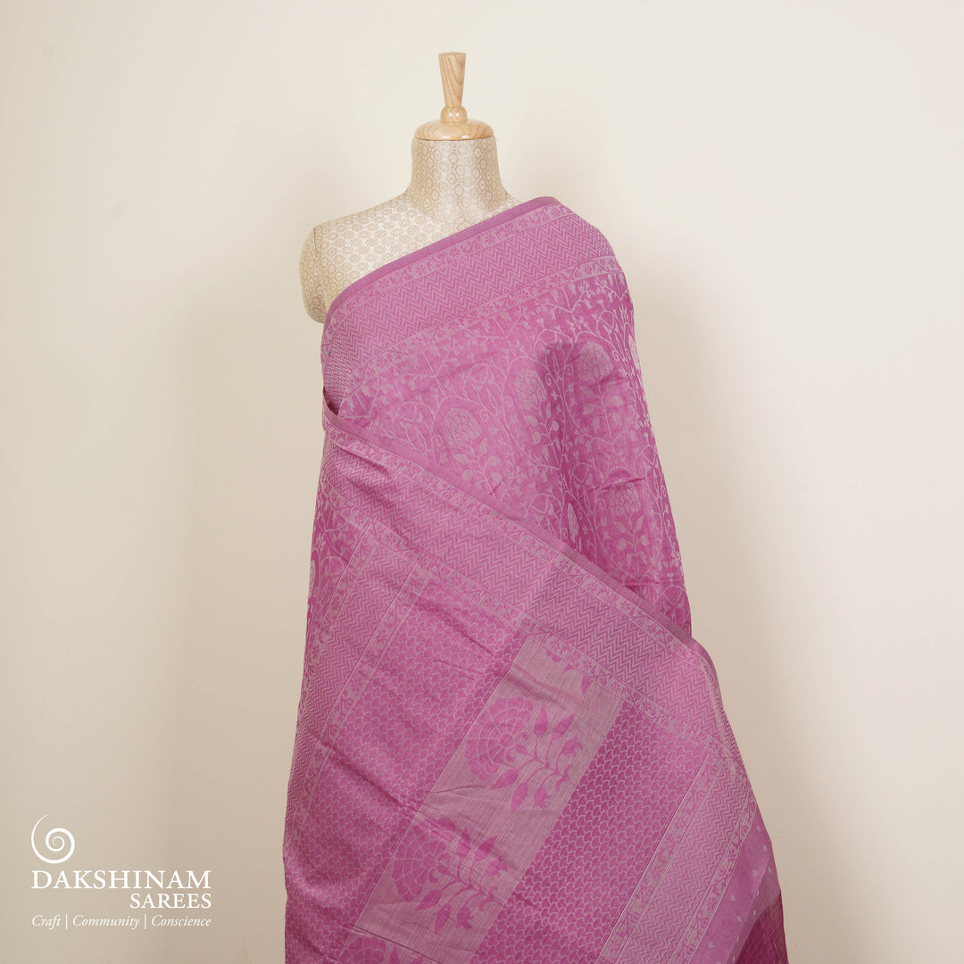 Pink South cotton saree with floral vine body pattern, vine border with chevron lines, patterned pallu and matching blouse with dot design.