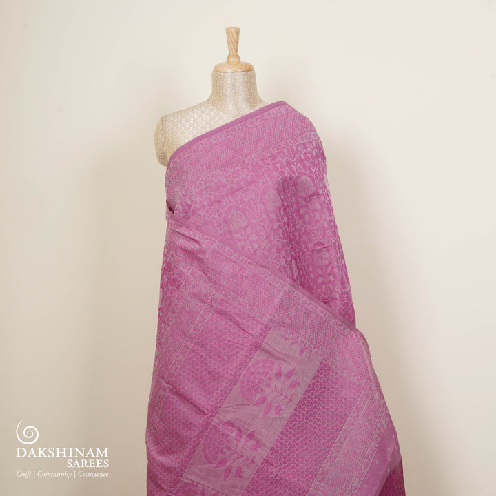 Pink South cotton saree with floral vine body pattern, vine border with chevron lines, patterned pallu and matching blouse with dot design.