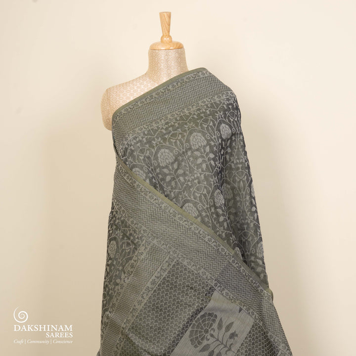 Black South cotton saree with floral vine body pattern, vine border with chevron lines, patterned pallu and matching blouse with dot design.