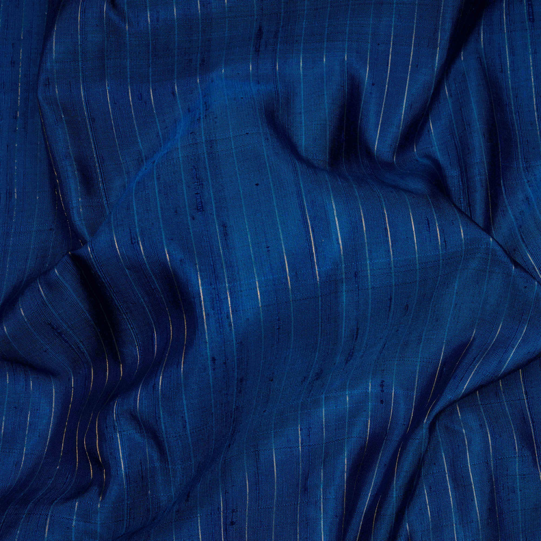 Blue Gadwal silk saree with raw silk finish body, silver stripe detailing, pink border with chakram and thazampoo motifs, pink blouse.