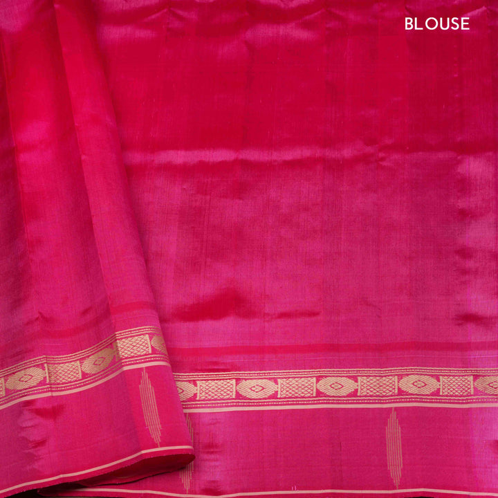 Blue Gadwal silk saree with raw silk finish body, silver stripe detailing, pink border with chakram and thazampoo motifs, pink blouse.
