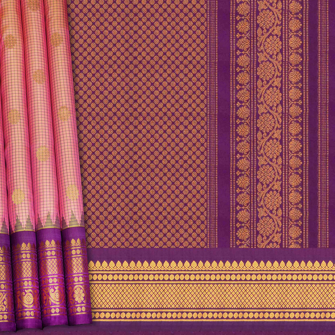 Dual tone pink and orange Gadwal silk saree with checkered body, purple zari border with rudraksh and temple motifs, plain purple blouse.
