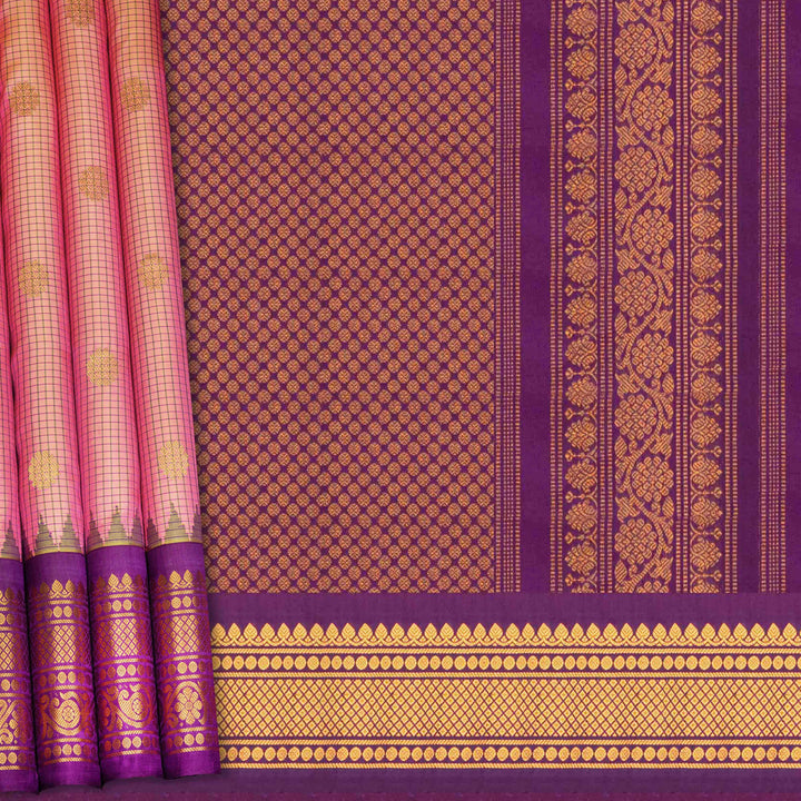 Dual tone pink and orange Gadwal silk saree with checkered body, purple zari border with rudraksh and temple motifs, plain purple blouse.