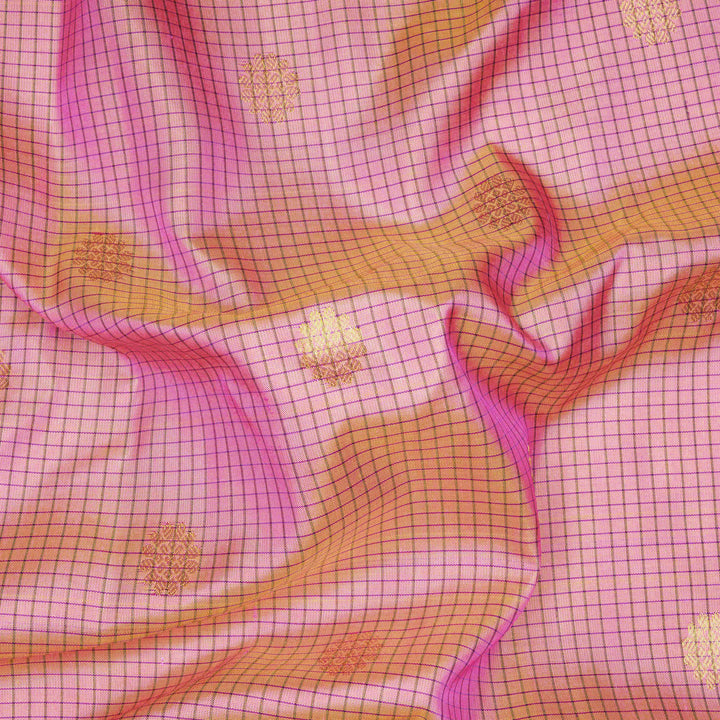Dual tone pink and orange Gadwal silk saree with checkered body, purple zari border with rudraksh and temple motifs, plain purple blouse.