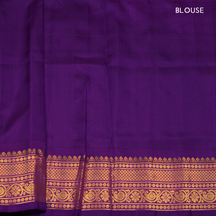 Dual tone pink and orange Gadwal silk saree with checkered body, purple zari border with rudraksh and temple motifs, plain purple blouse.