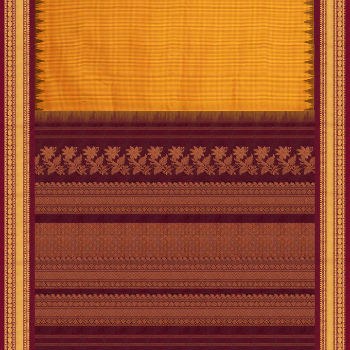 Yellow Gadwal silk saree with maroon checks and small butta body, maroon zari border with chakram and temple motifs, plain maroon blouse.
