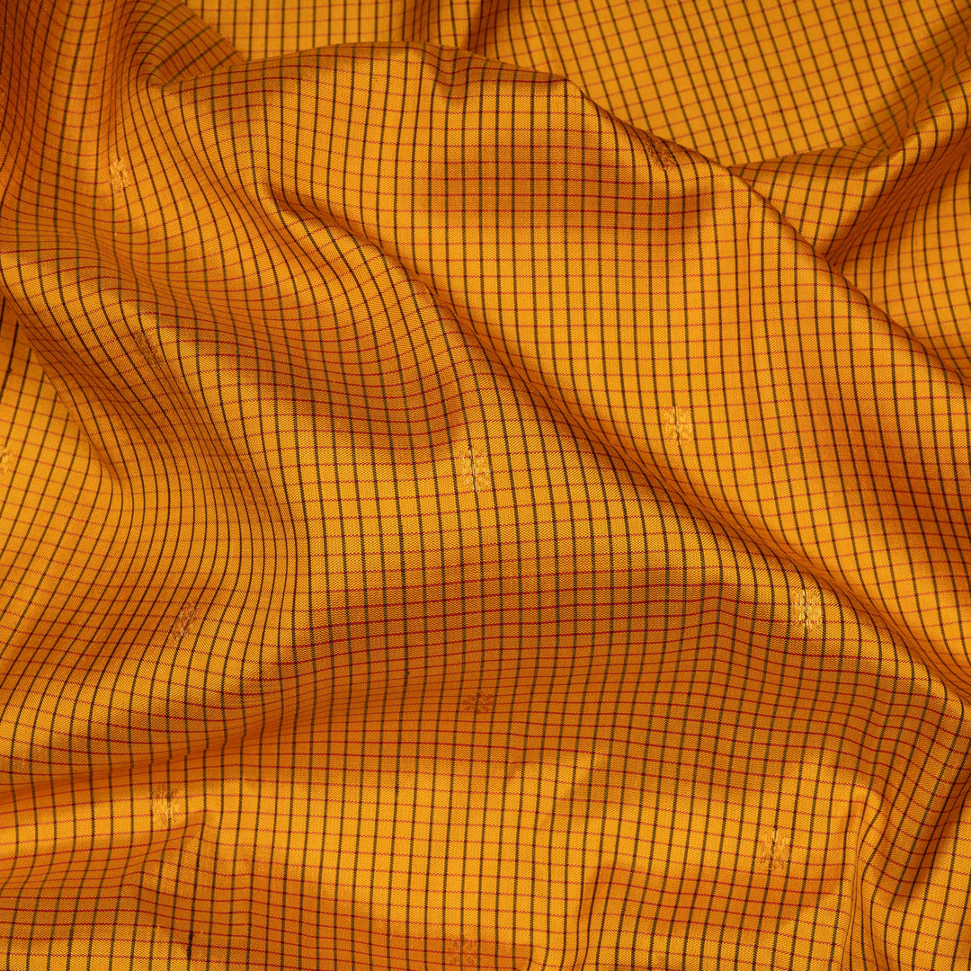 Yellow Gadwal silk saree with maroon checks and small butta body, maroon zari border with chakram and temple motifs, plain maroon blouse.