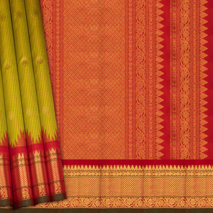 Lime green Gadwal silk saree with red check lines and small butta body, red zari border with rudraksh and mango motifs, plain red blouse.